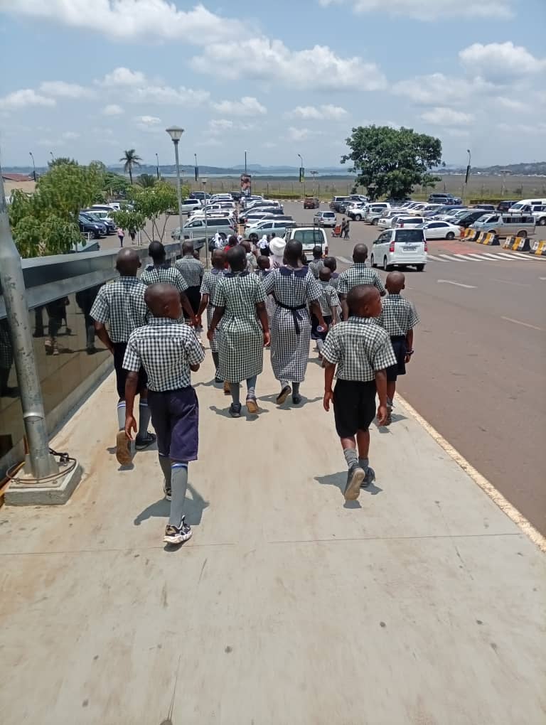 Pupils gathered under the trees on the St. Mary's school compound