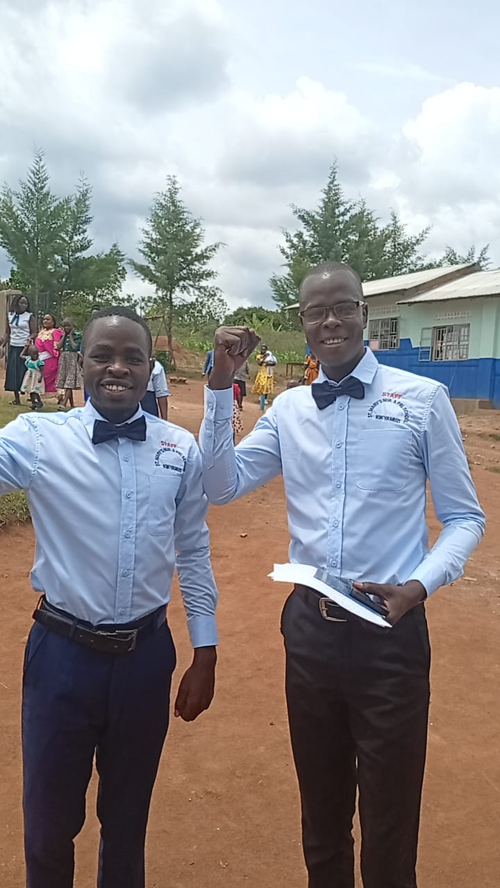 St. Mary's staff members near the school compound in Kikyamuzi